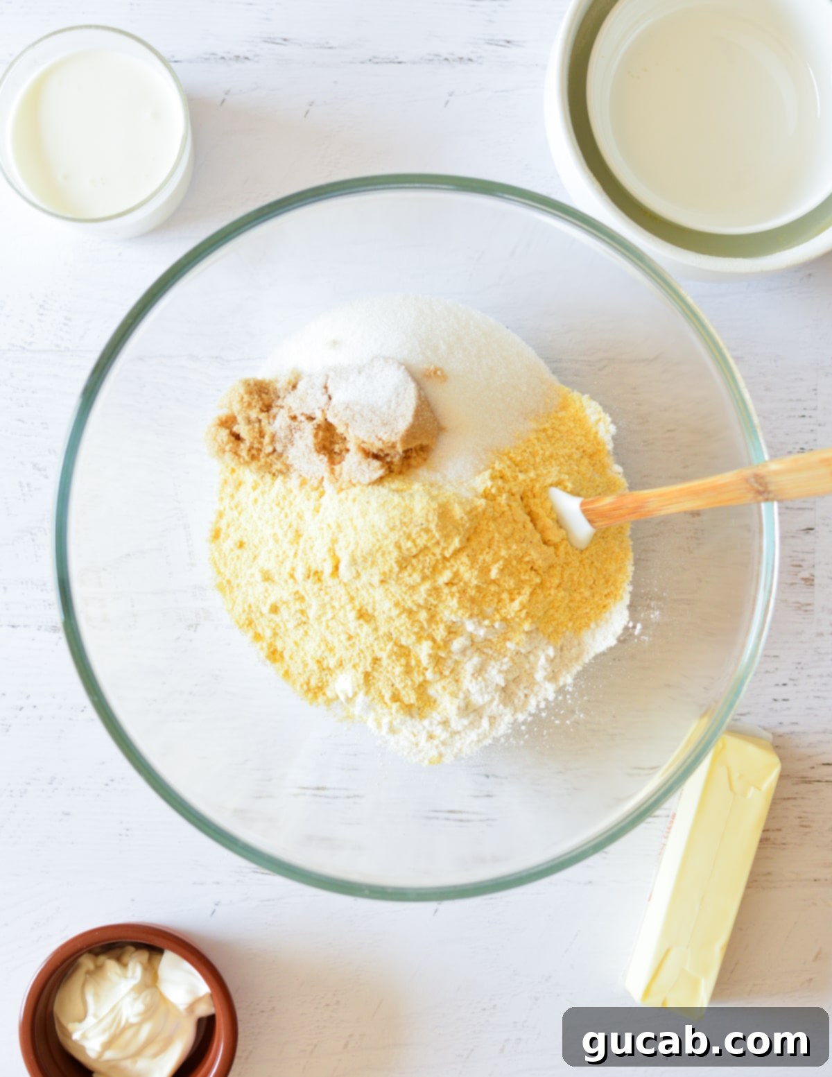 a bowl with sugar, brown sugar, cornmeal, and flour. 