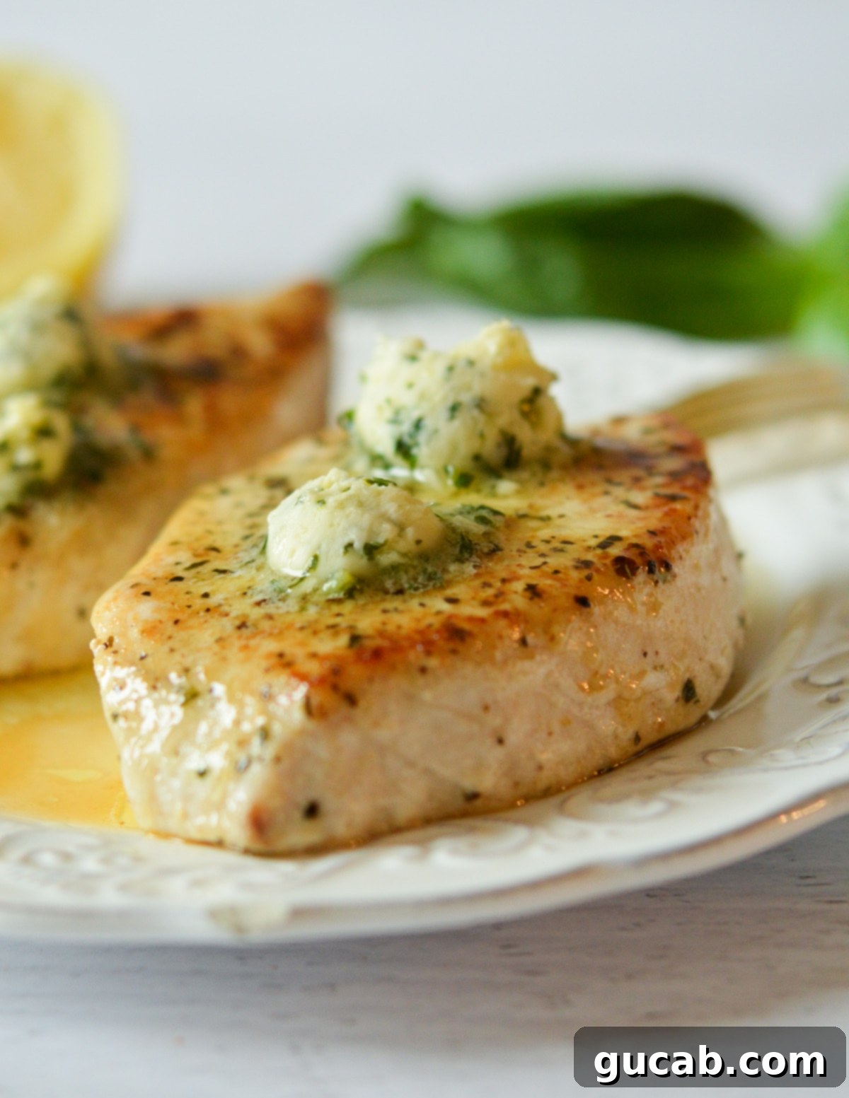 cooked swordfish with lemon basil butter on top. 