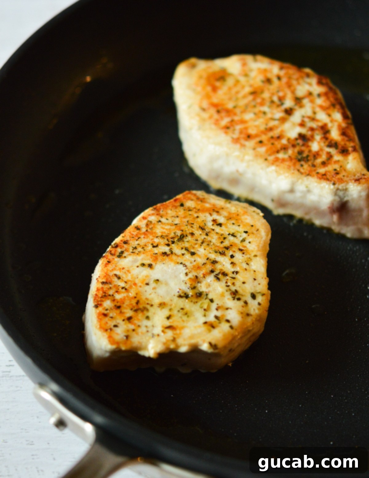 caramelized swordfish fillet in pan. 