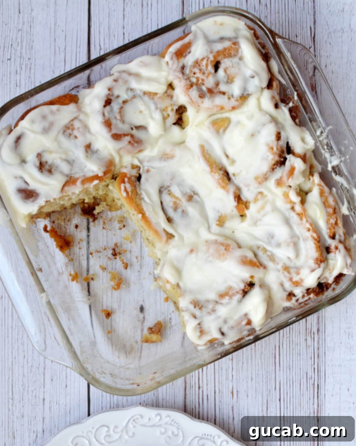 A pan of warm, frosted gluten-free cinnamon rolls, fresh from the oven.