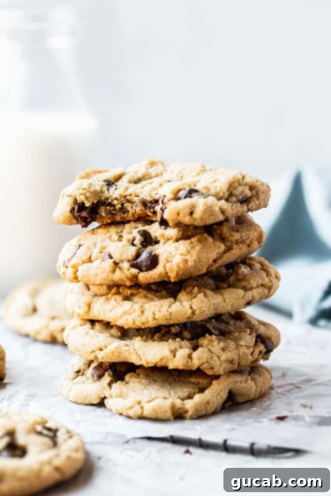 A stack of perfectly baked gluten-free chocolate chip cookies with a crisp exterior and chewy interior.