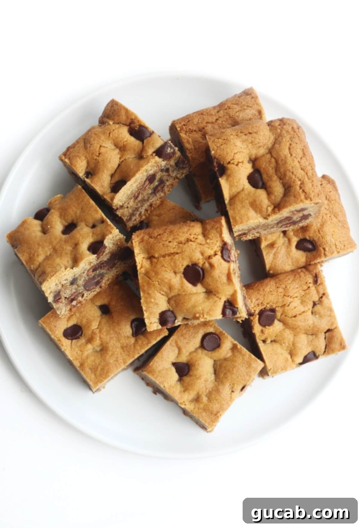 Thick, soft gluten-free chocolate chip cookie bars on a plate, ready to serve.