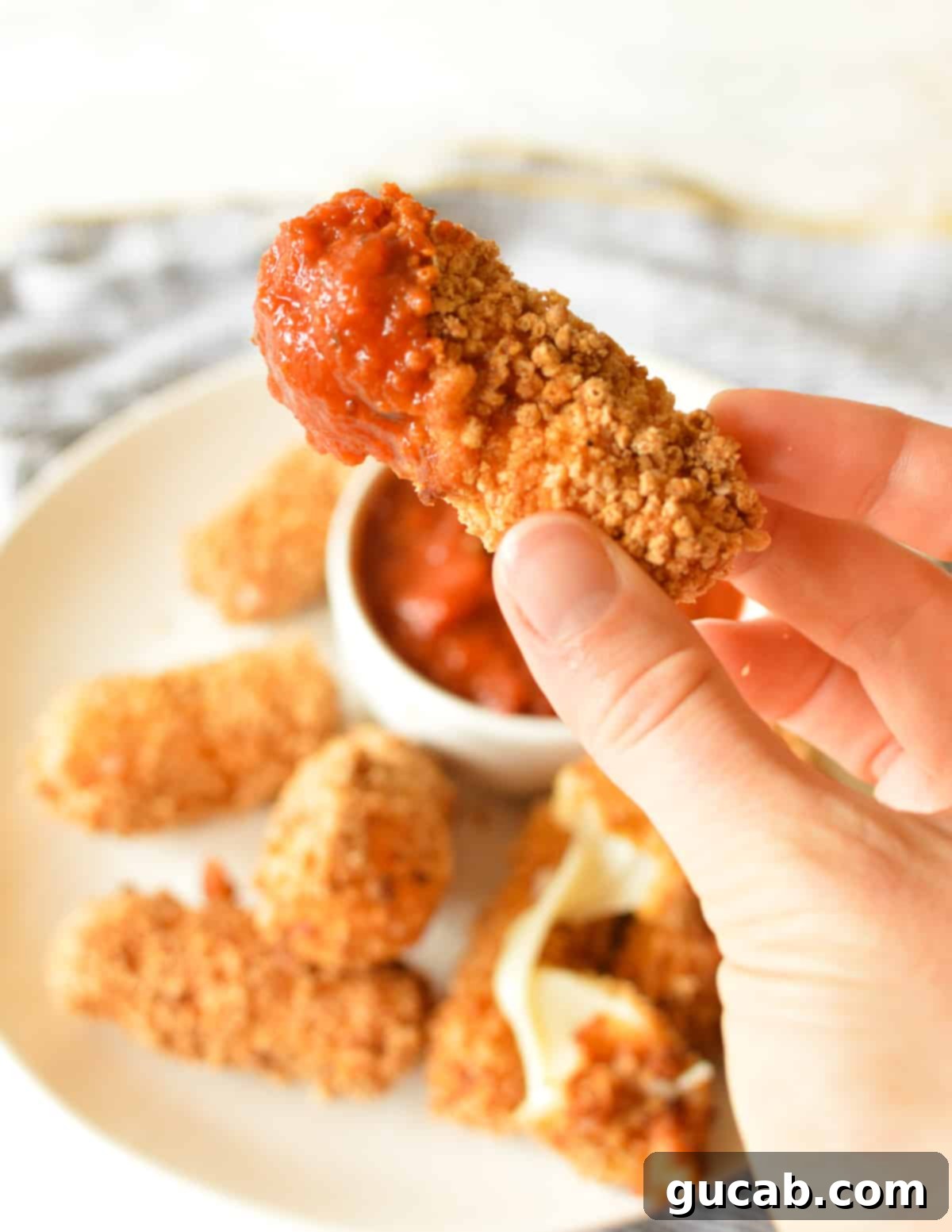 Irresistible Gluten-Free Mozzarella Sticks 13 a mozzarella stick dipped in marinara