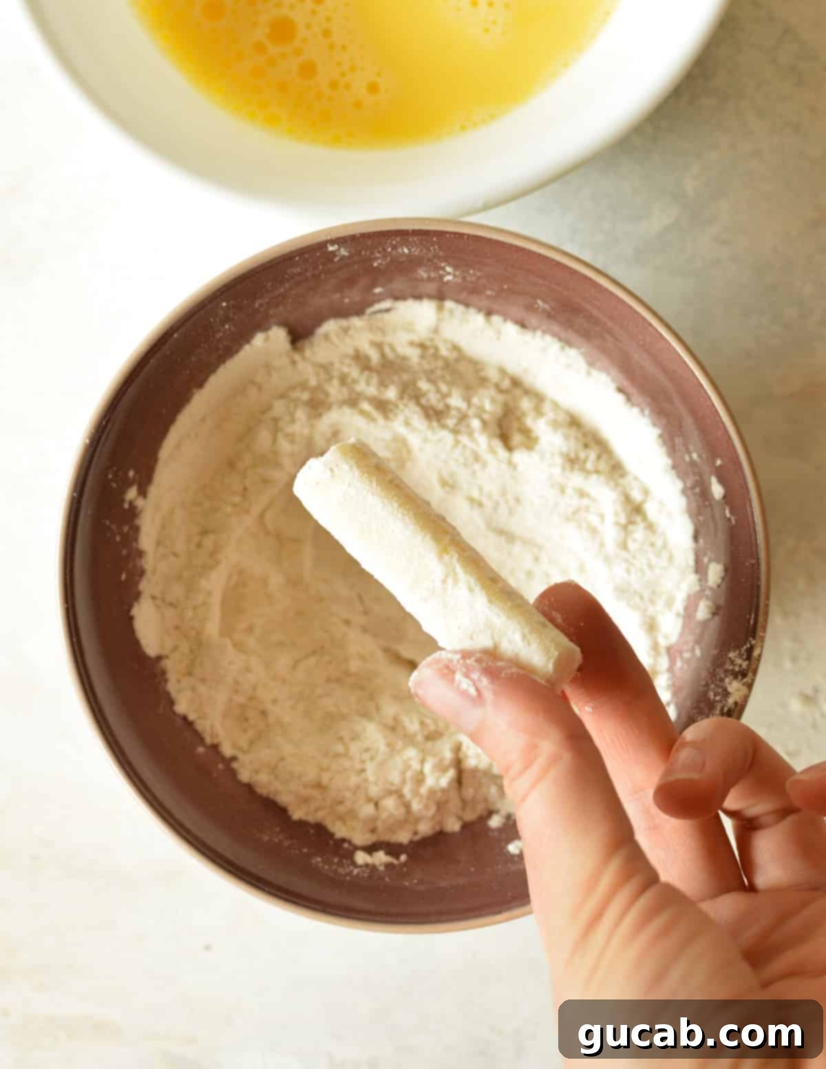 Irresistible Gluten-Free Mozzarella Sticks 5 a cheese stick covered in gluten free flour