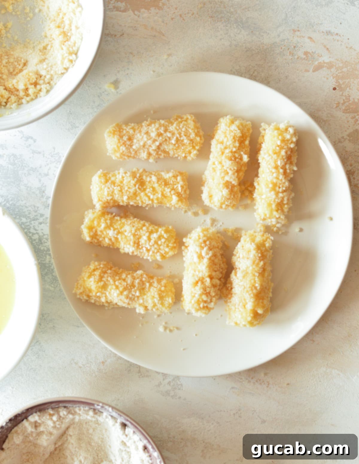 Irresistible Gluten-Free Mozzarella Sticks 10 coated cheese sticks on a clean plate