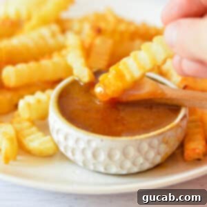 sweet and sour sauce with french fries.
