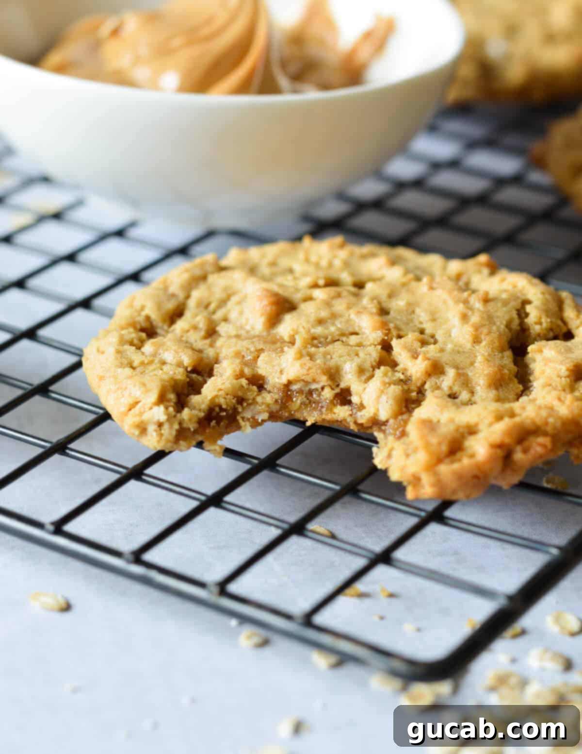 peanut butter cookie with a bite out of it on a wire rack. 