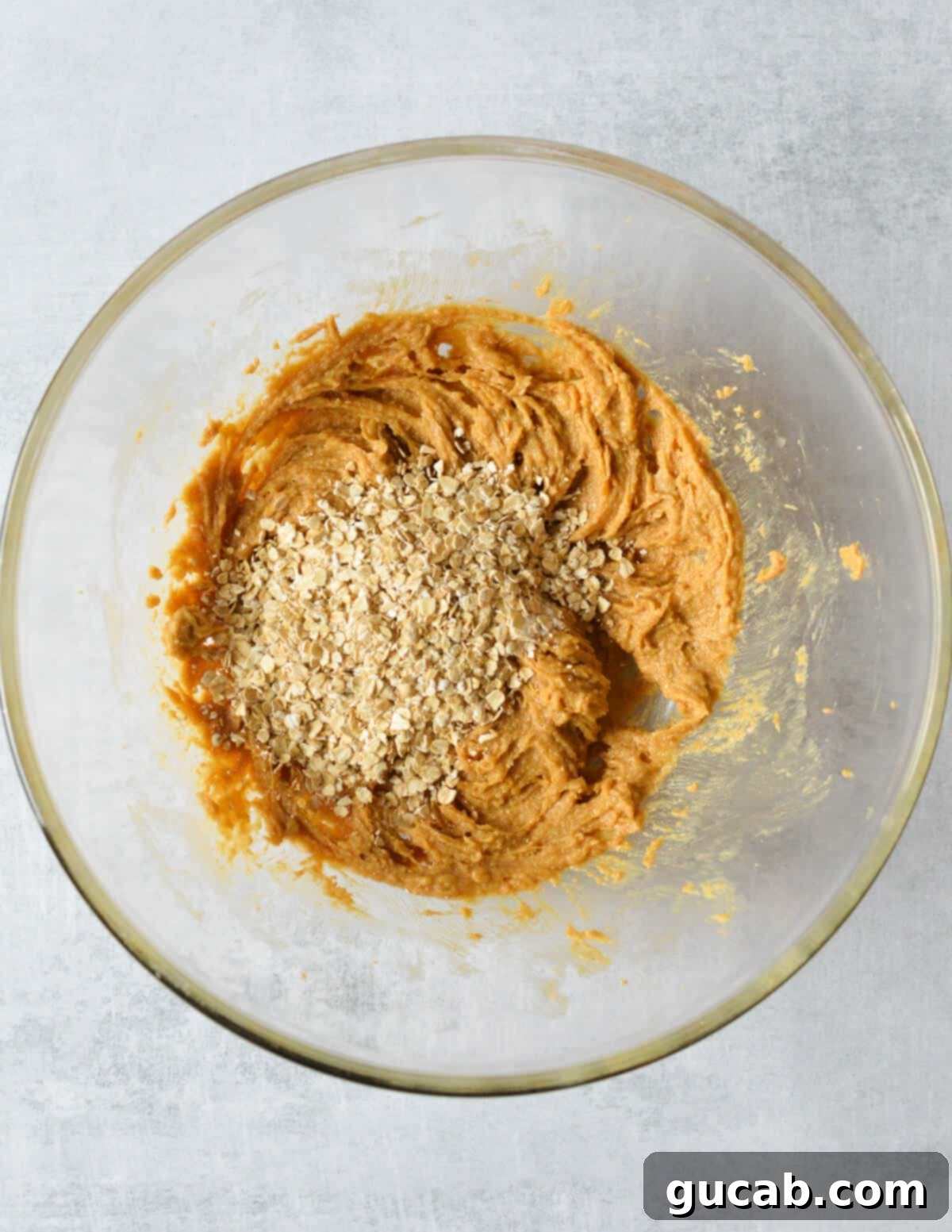 a bowl of peanut butter with quick oats on top. 