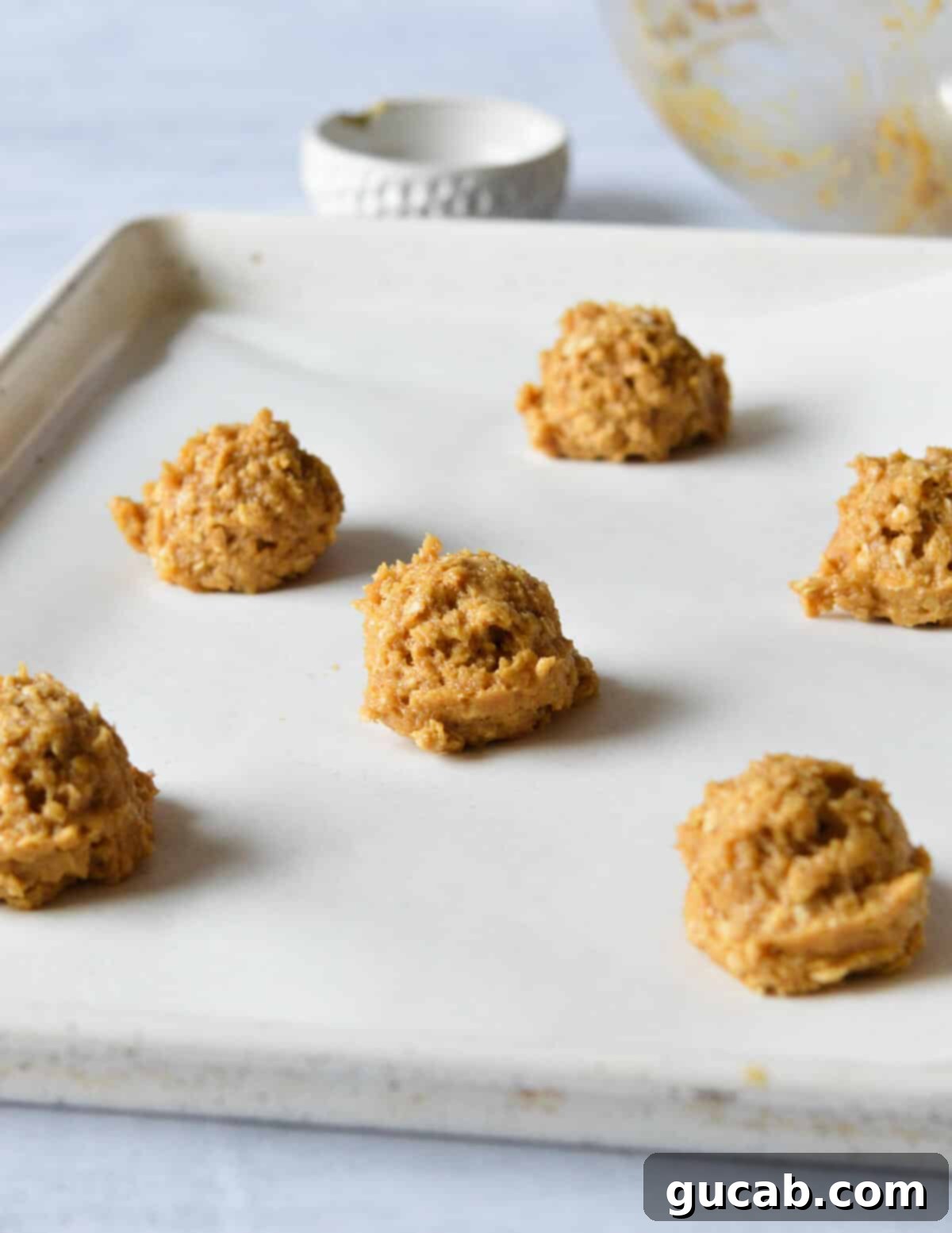peanut butter cookie dough balls on a sheet pan. 