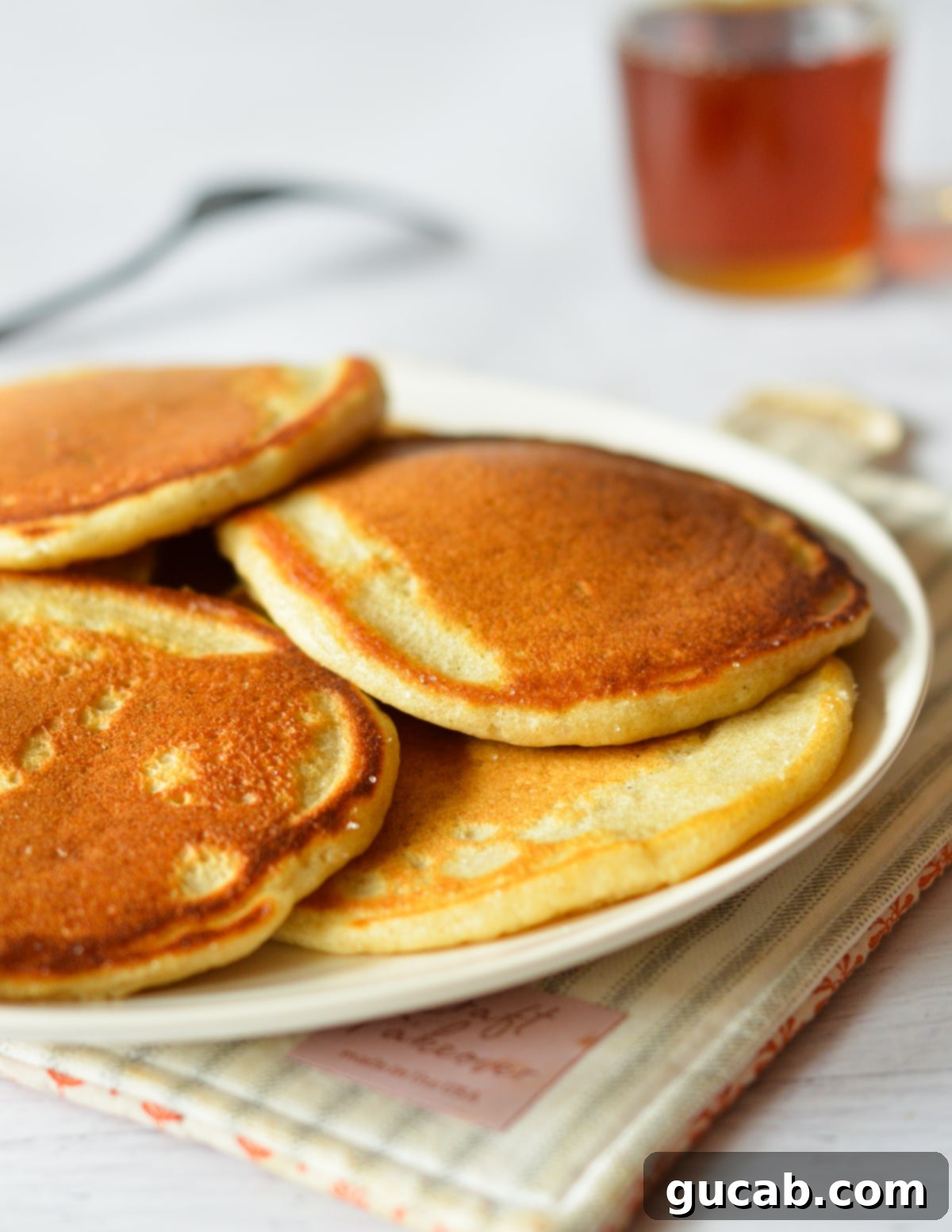 A plate featuring a stack of perfectly golden-brown crispy pancakes, garnished and ready to be served and enjoyed.