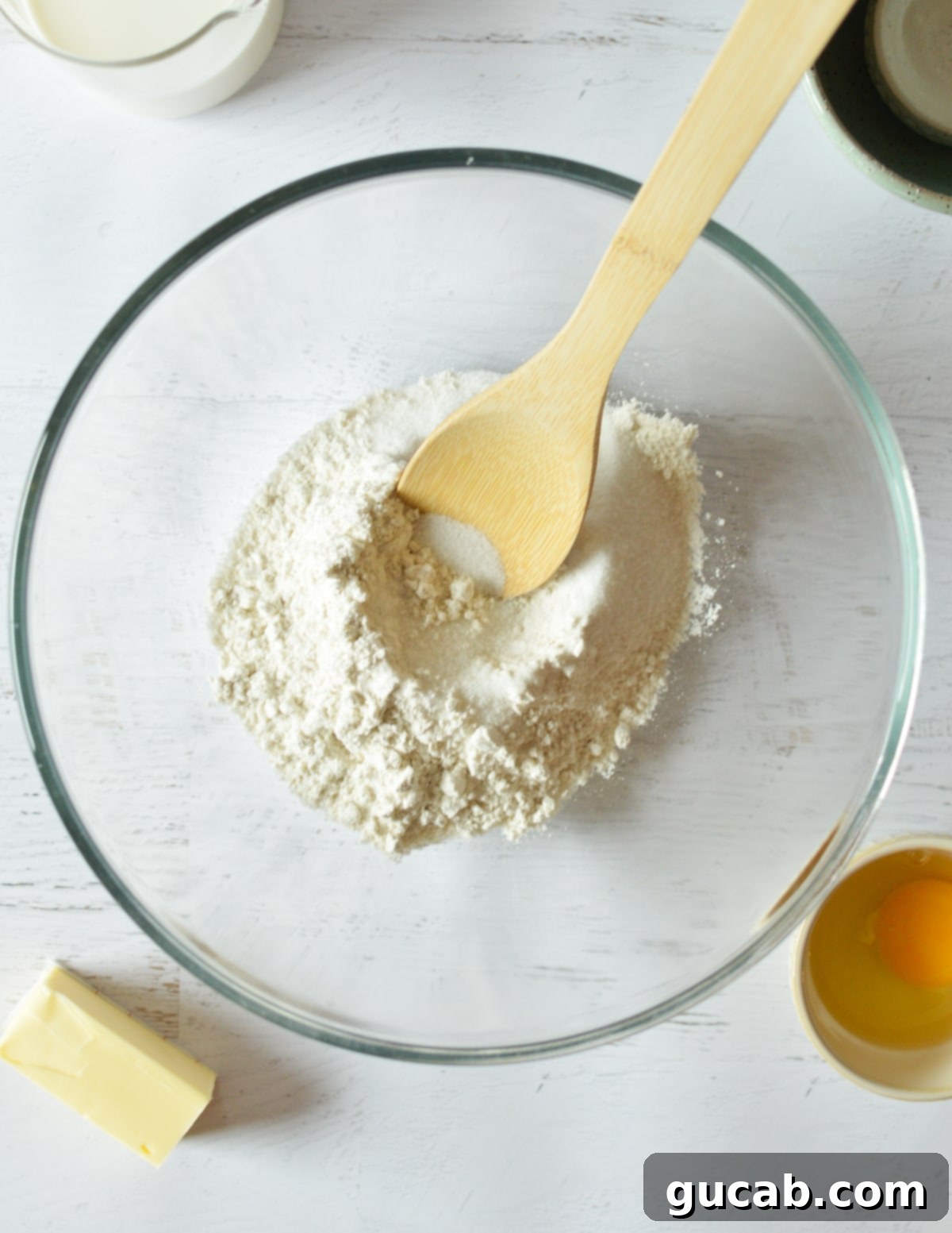 A bowl containing a well-mixed blend of all-purpose flour, granulated sugar, baking powder, baking soda, and kosher salt.