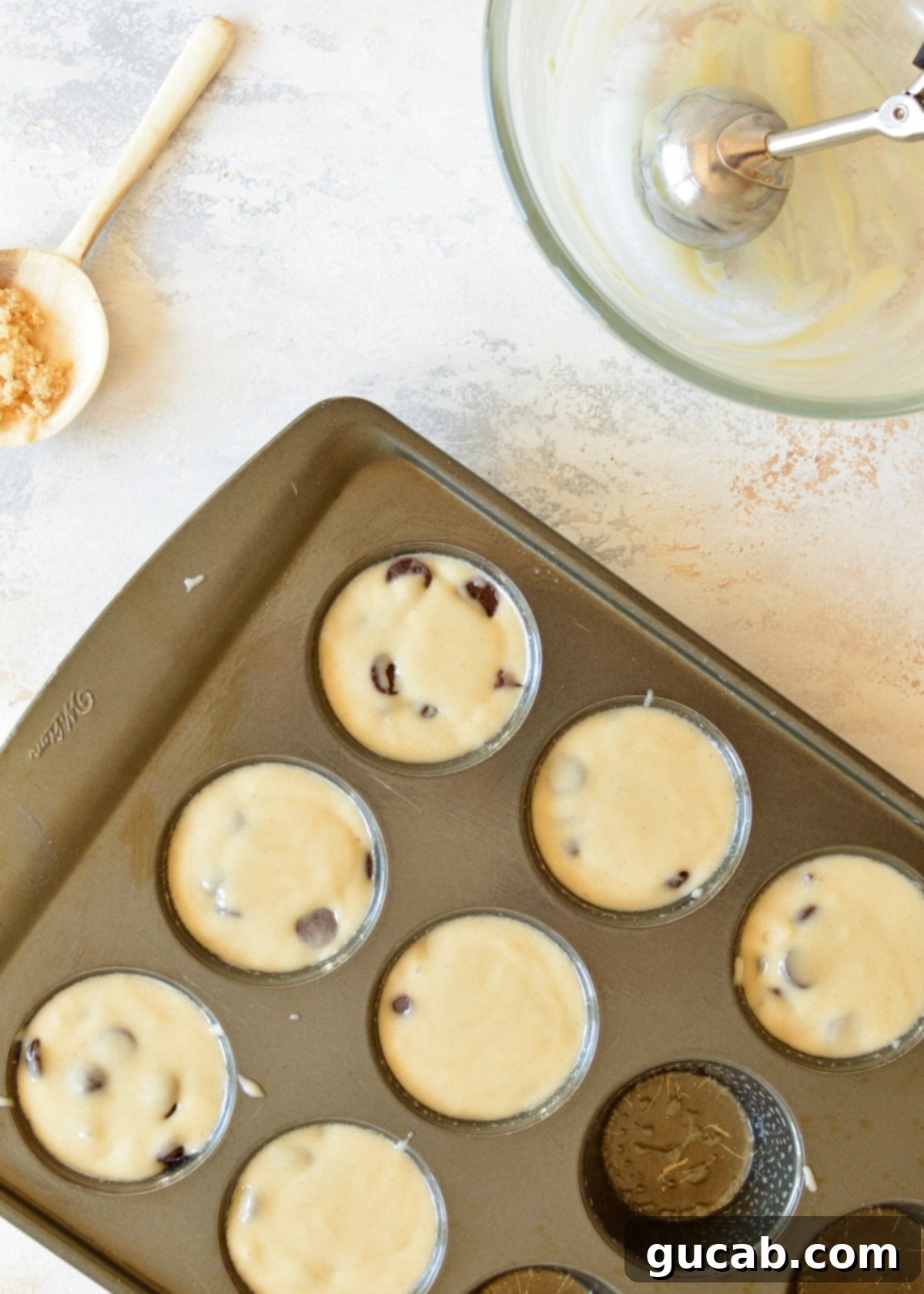 gluten free muffin batter in a muffin tin