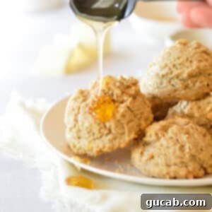 drizzling honey onto an oat flour biscuit.