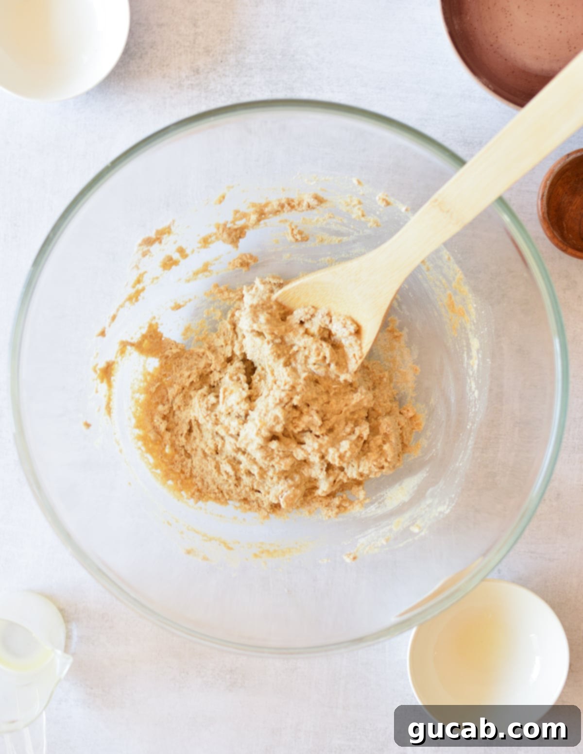 A bowl of wet oat flour biscuit dough, having just been chilled and ready for scooping.