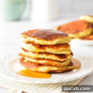 Fluffy Honey Pancakes 13 a stack of pancakes with maple syrup.