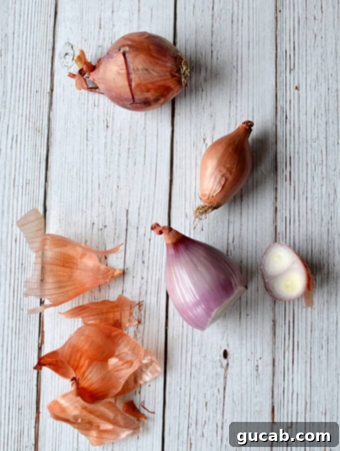 Peeled shallots ready for slicing, showcasing their delicate purple and white layers, prepared for the pickling process.