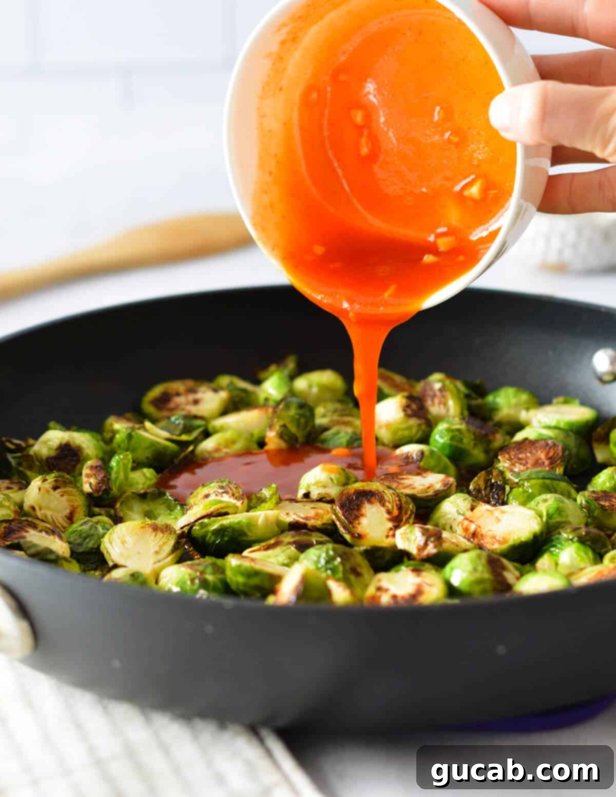 The final delicious result: honey sriracha brussels sprouts glistening with glaze, fresh out of the pan.