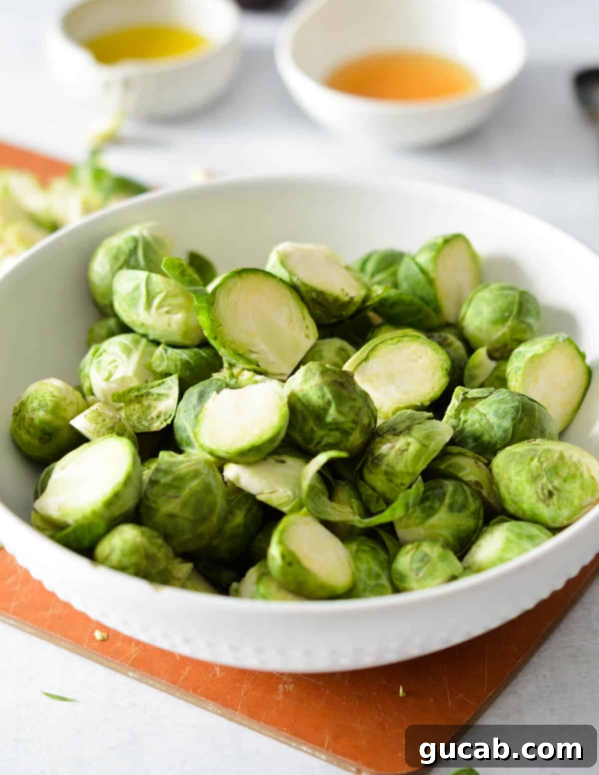 A bowl filled with freshly cut brussels sprouts, showing their vibrant green color and readiness for the recipe.