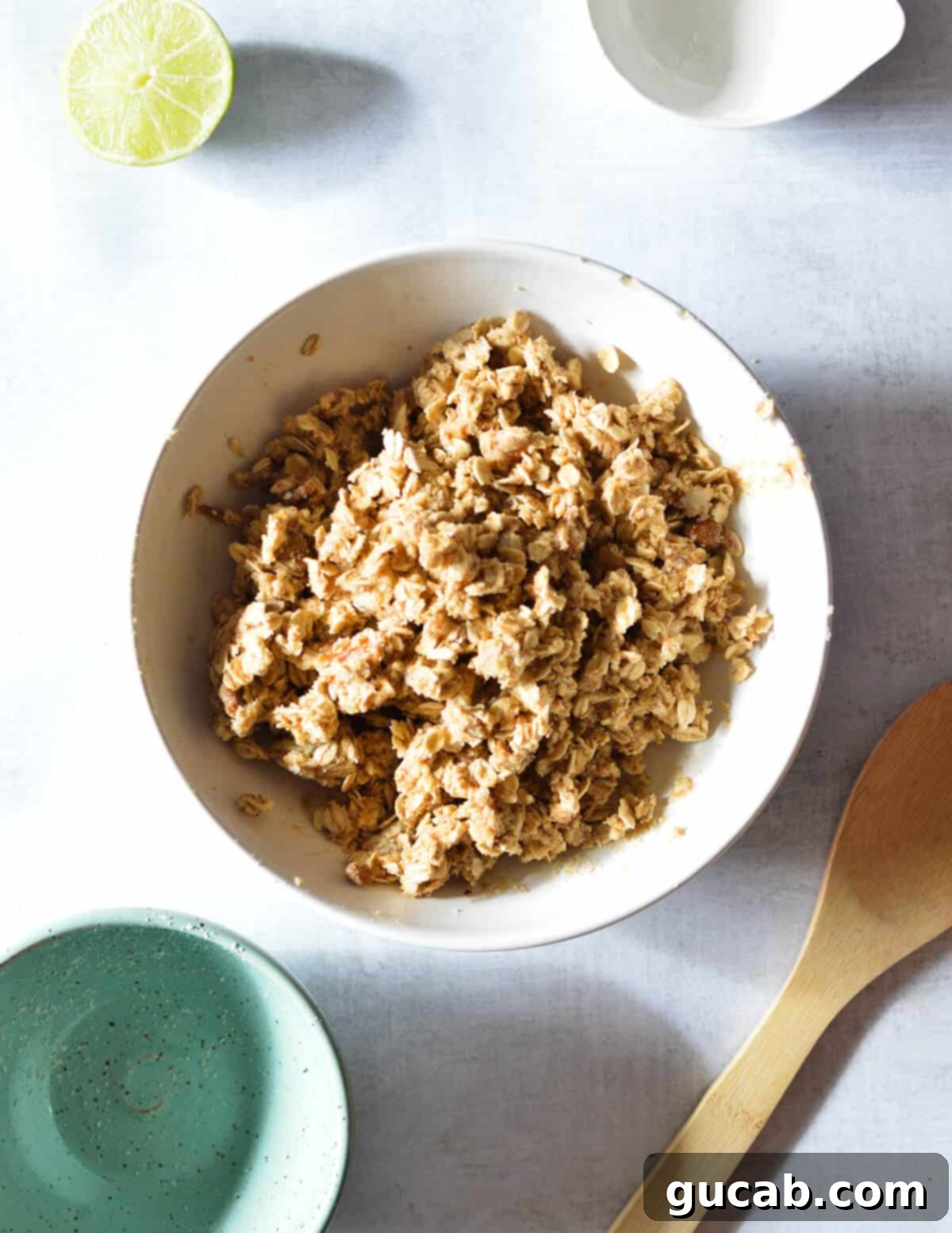 A bowl of crumb topping, perfectly mixed and ready to be spread over the blueberry filling.