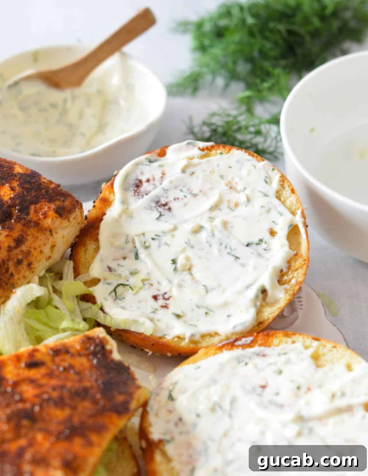 A toasted brioche top bun generously spread with homemade lemon aioli.