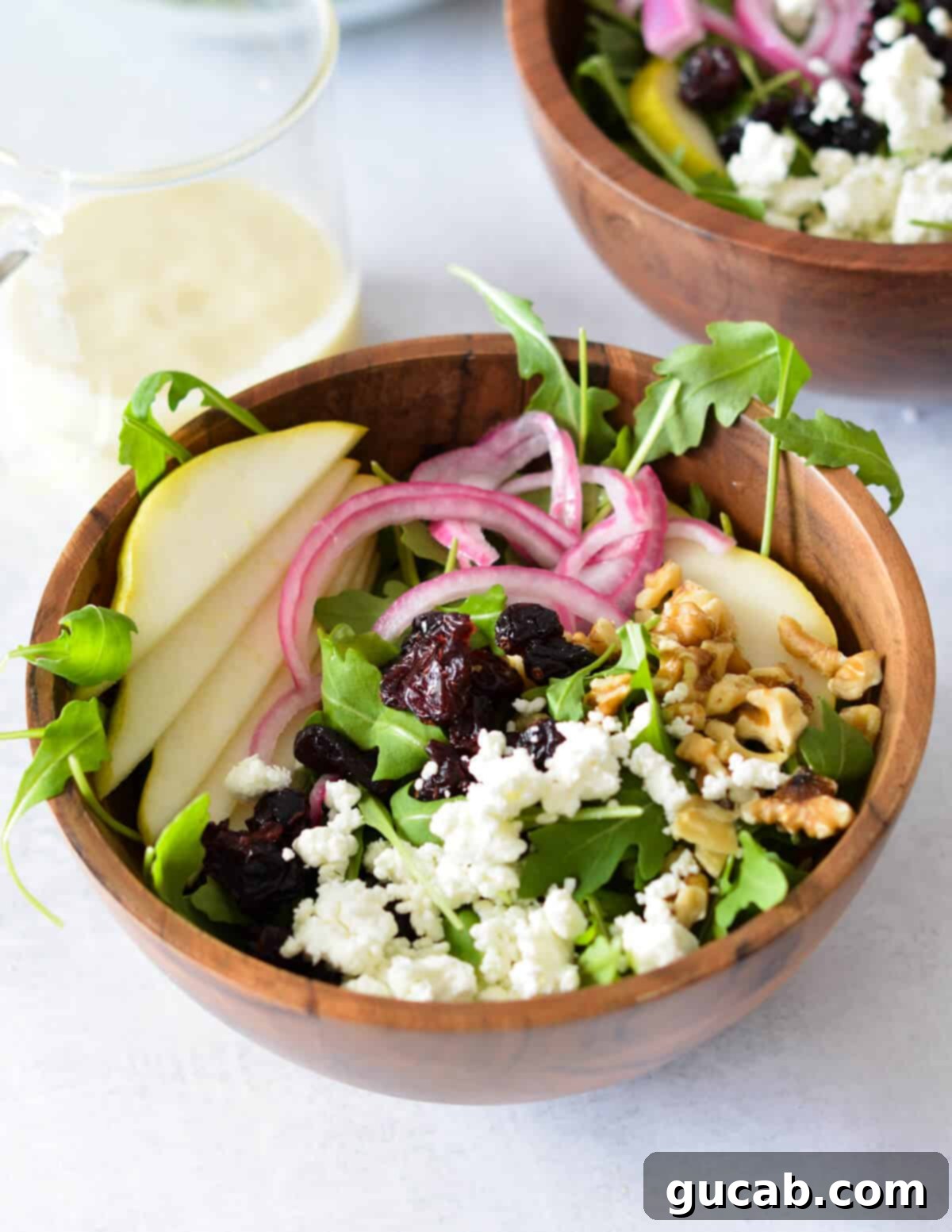 arugula salad with pears, red onion, goat cheese, and walnuts.