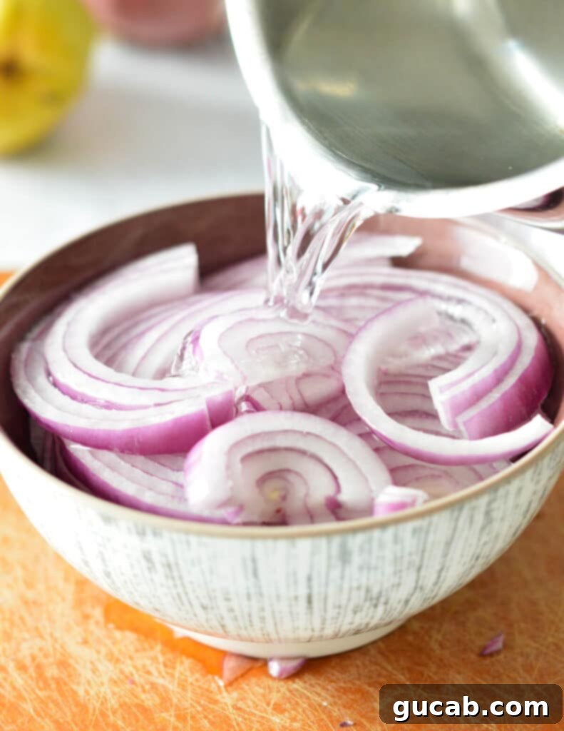 pouring hot water onto red onions.