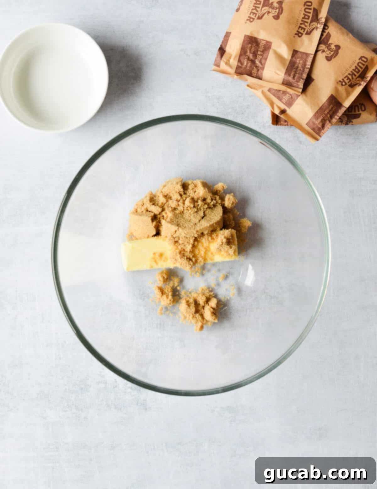 Speedy Oatmeal Delights 4 a bowl of butter and brown sugar.