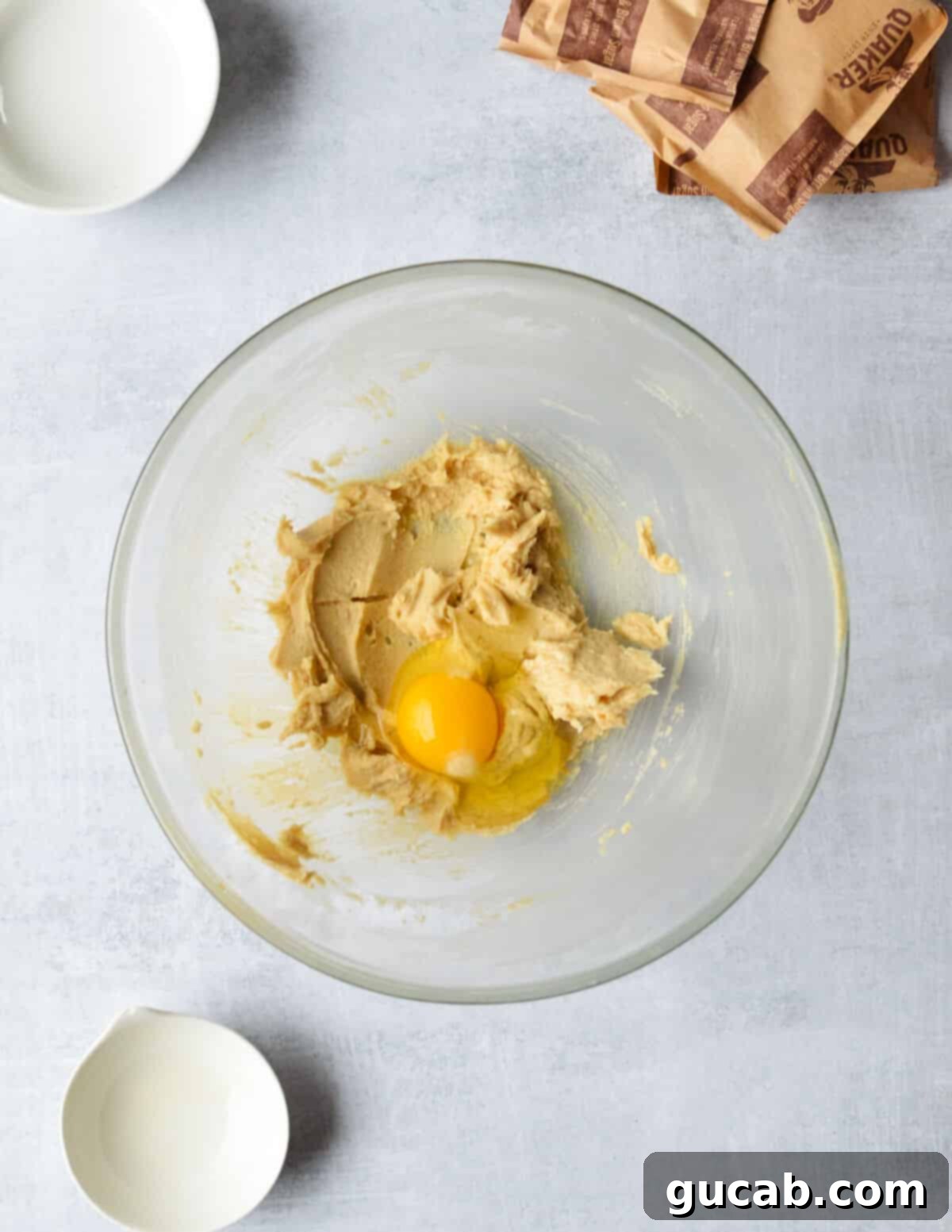 Speedy Oatmeal Delights 6 a bowl of creamed butter and sugar with an egg on top.