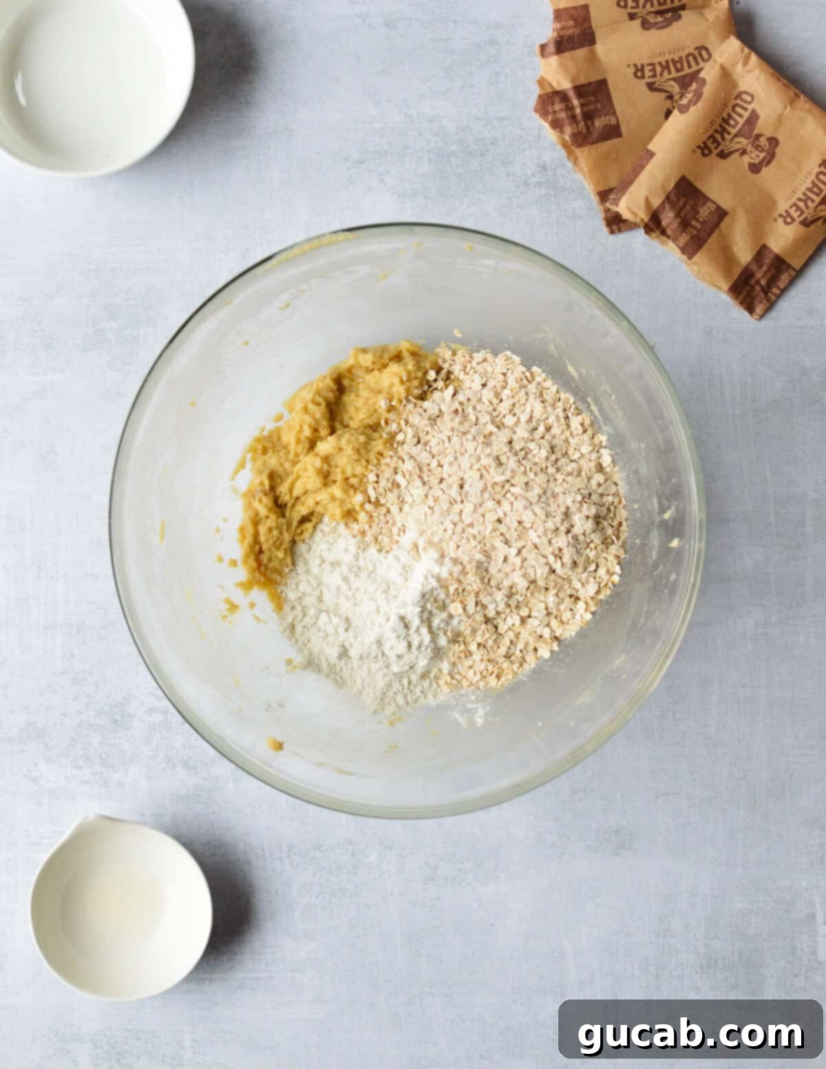 Speedy Oatmeal Delights 8 creamed butter and sugar with oats and flour in a bowl.