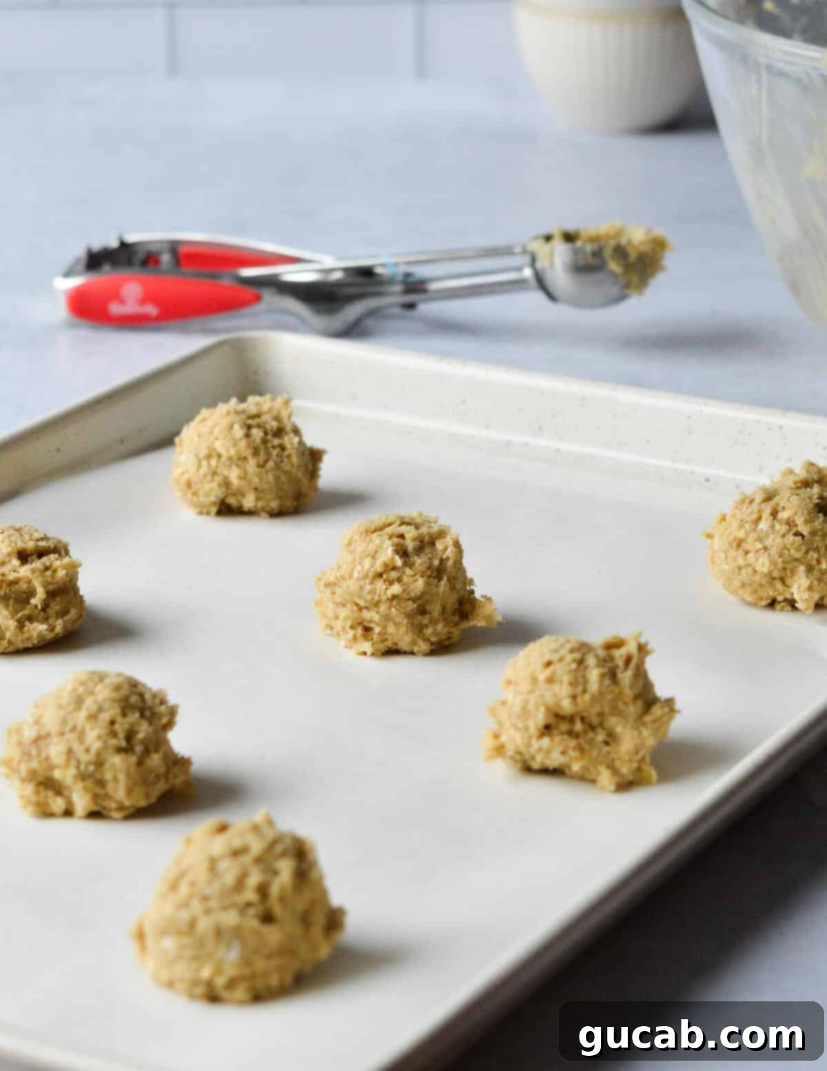 Speedy Oatmeal Delights 10 oatmeal cookie dough on a sheet pan.
