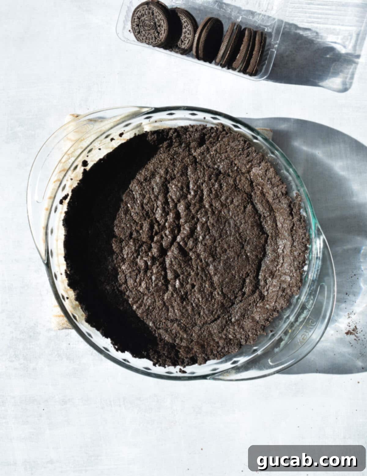 The Ultimate Gluten-Free Oreo Pie Crust 12 baked chocolate cookie crust in pie pan.