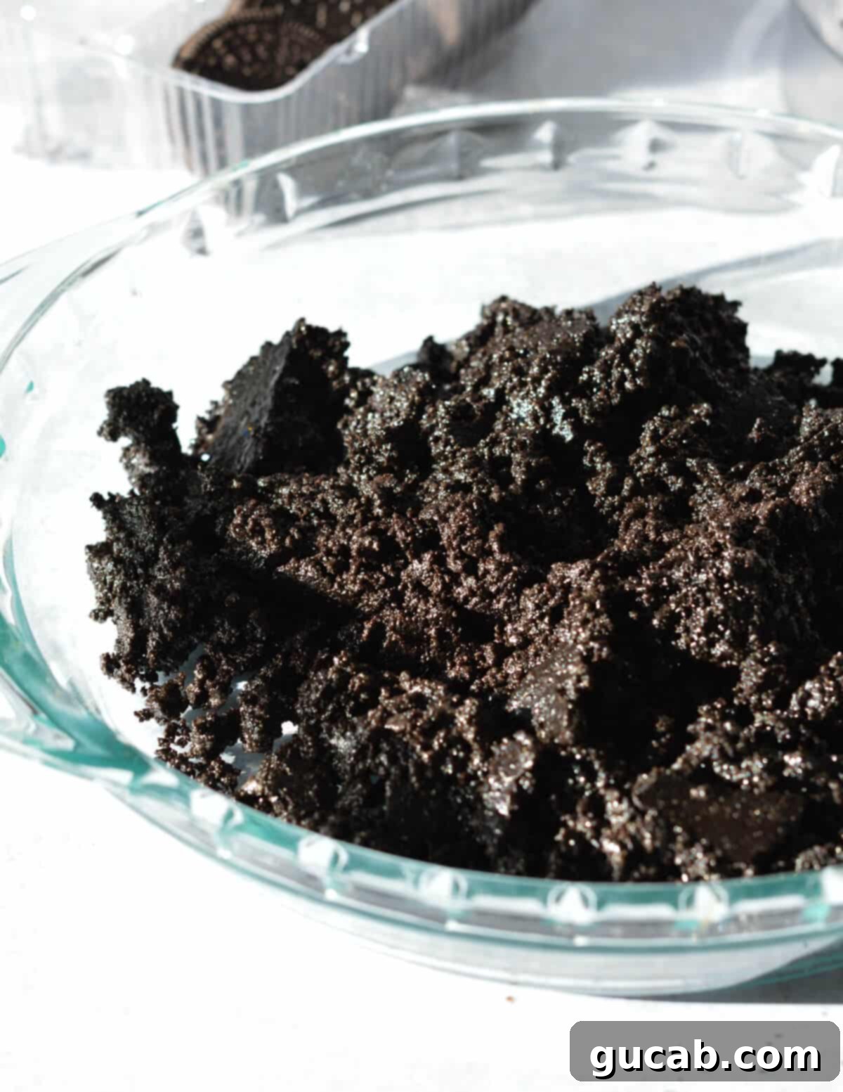 The Ultimate Gluten-Free Oreo Pie Crust 8 ground chocolate cookie mixture in pie pan.