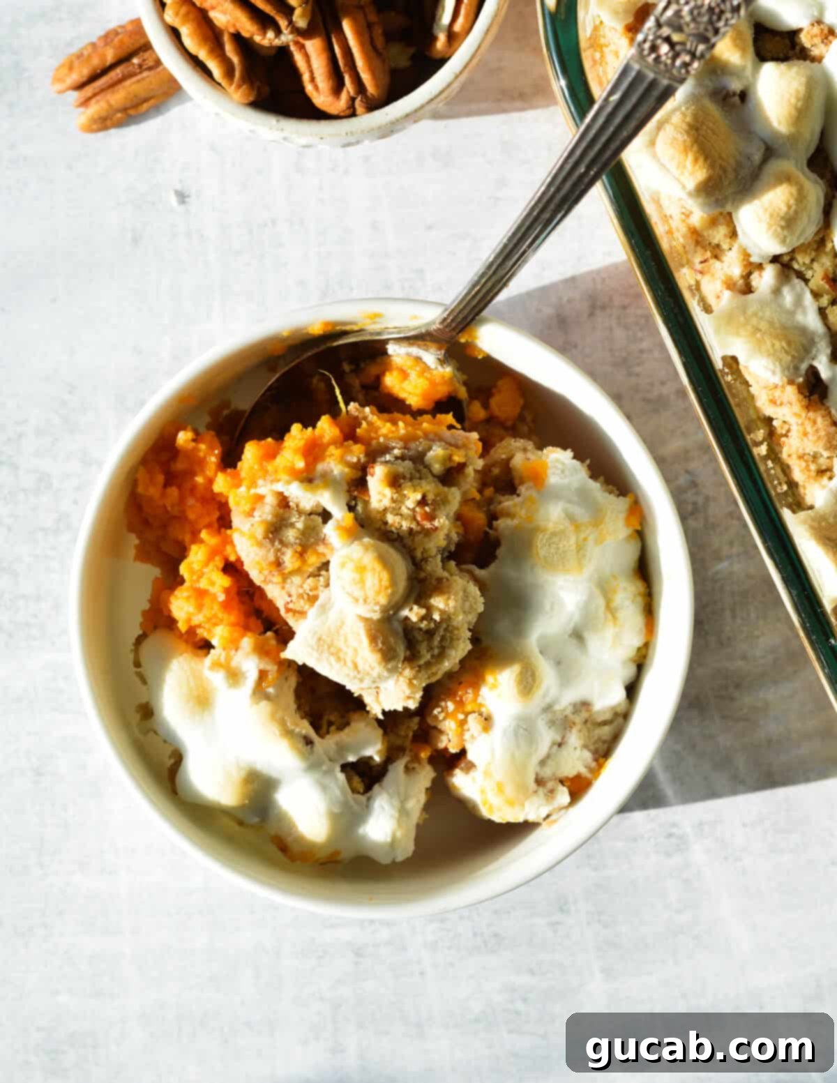 Heavenly Sweet Potato Casserole 17 A bowl of sweet potato casserole, artfully arranged with crumb topping and marshmallows, signifying its readiness.