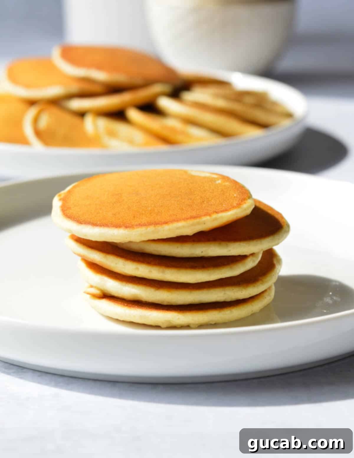a stack of mini pancakes on a plate. 