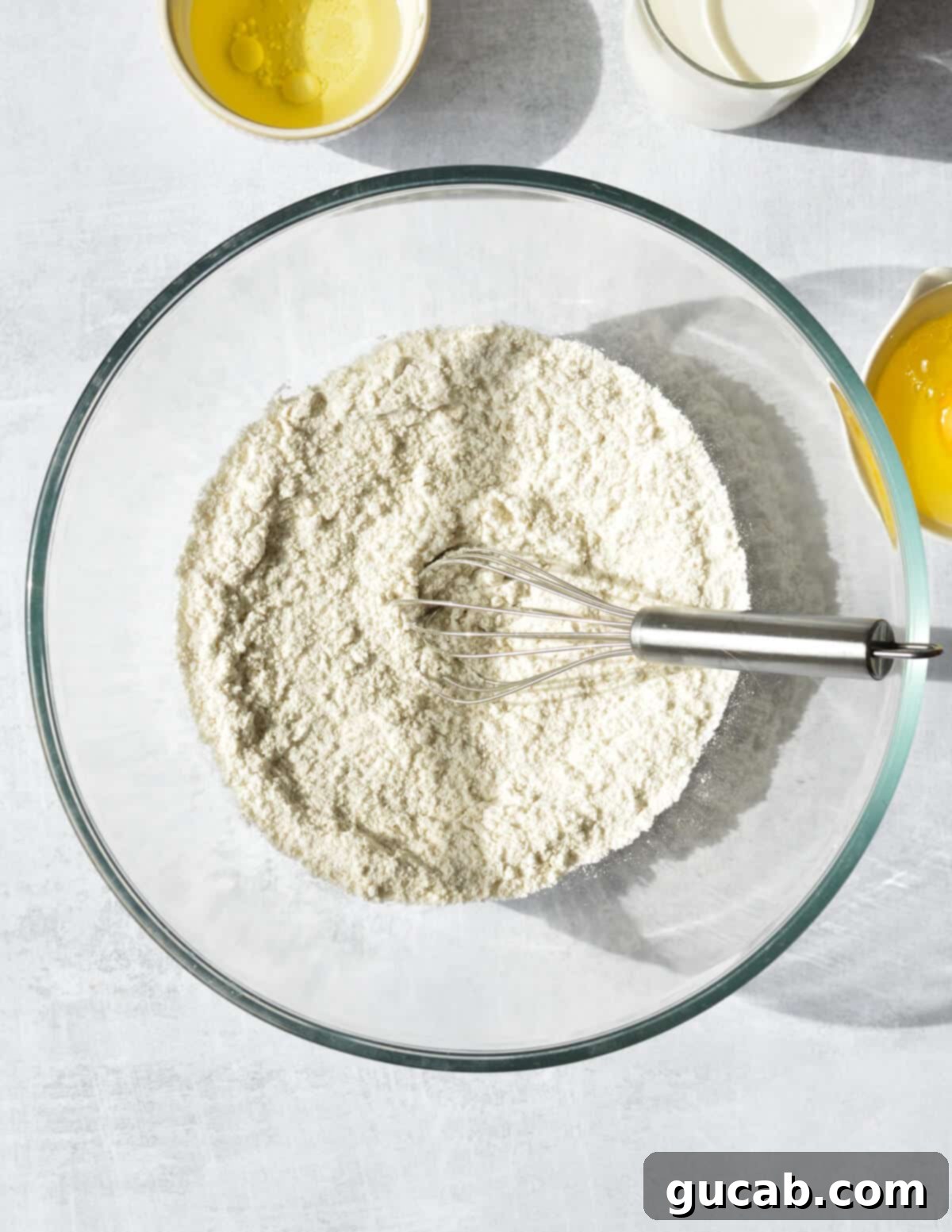 a bowl of flour, sugar, and salt.