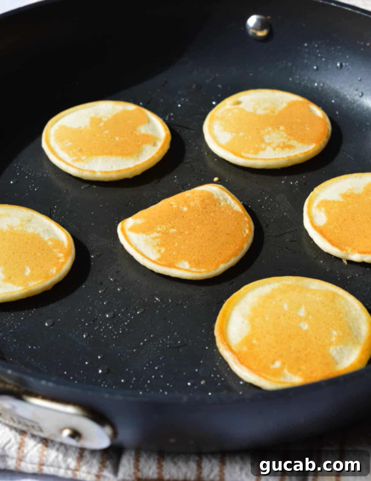 small pancakes in a skillet. 