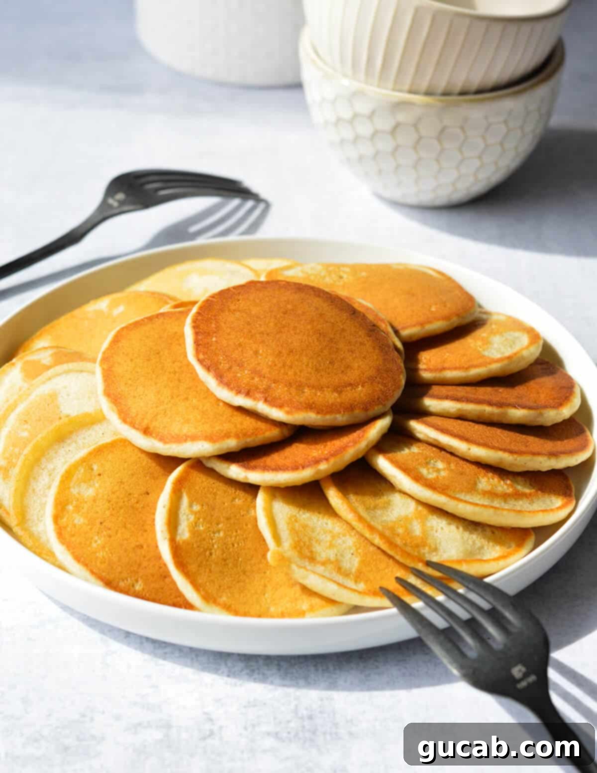 a plate of silver dollar pancakes. 