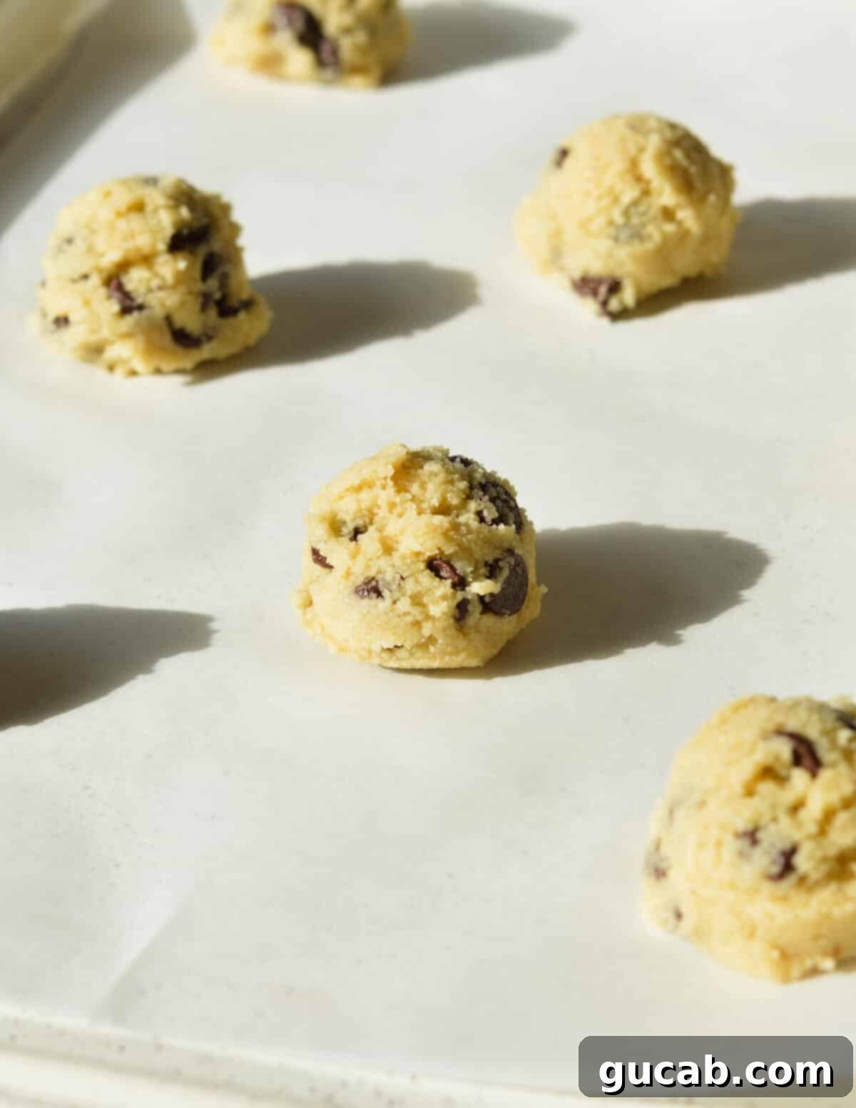 cookie dough balls on a sheet pan. 