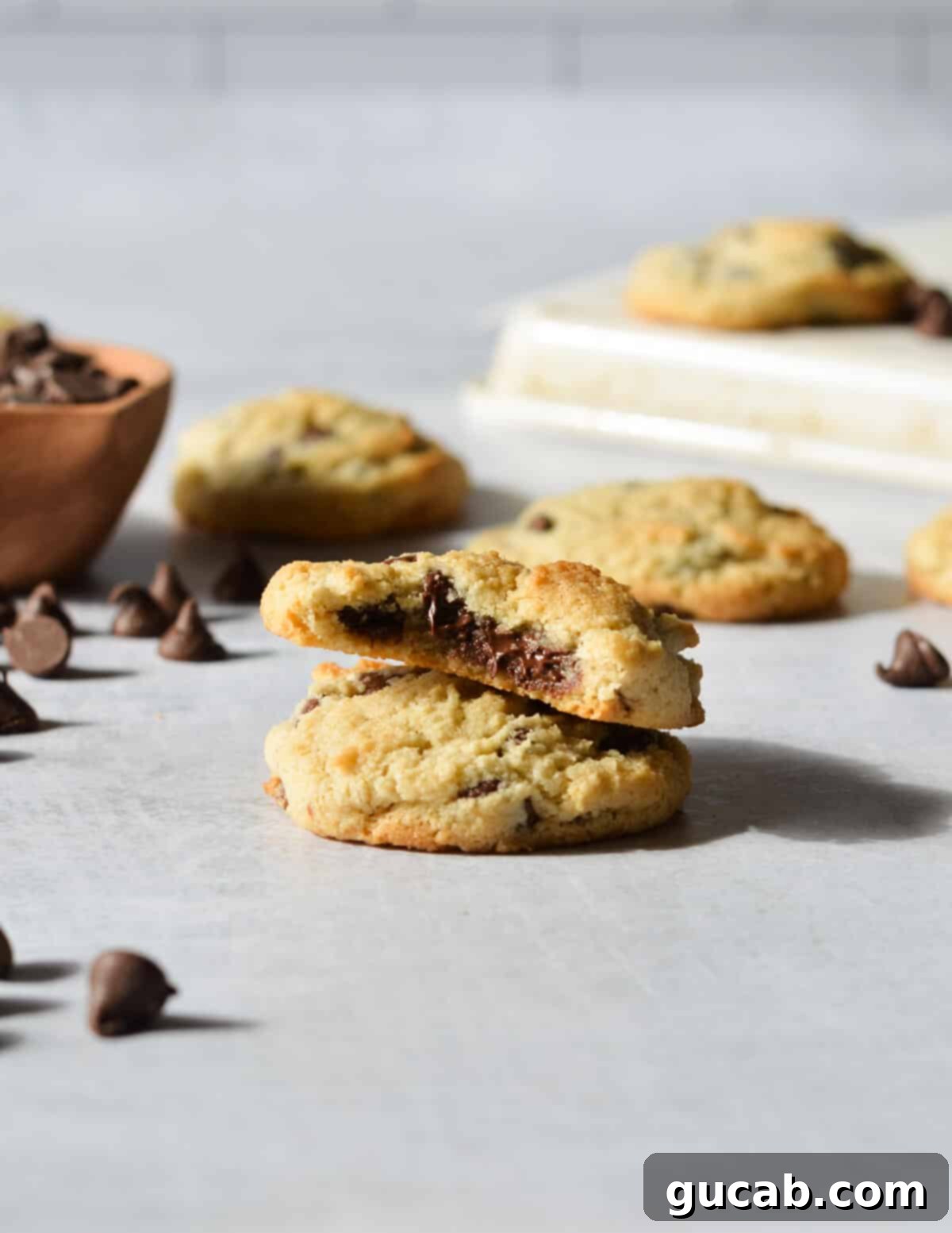 a stack of two cookies, one with a bite out of it. 