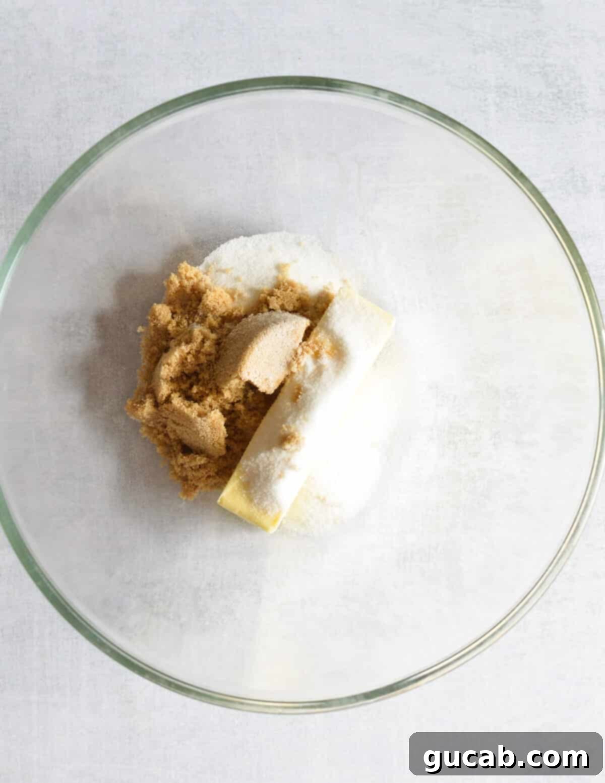 a bowl of butter, sugar, and brown sugar. 
