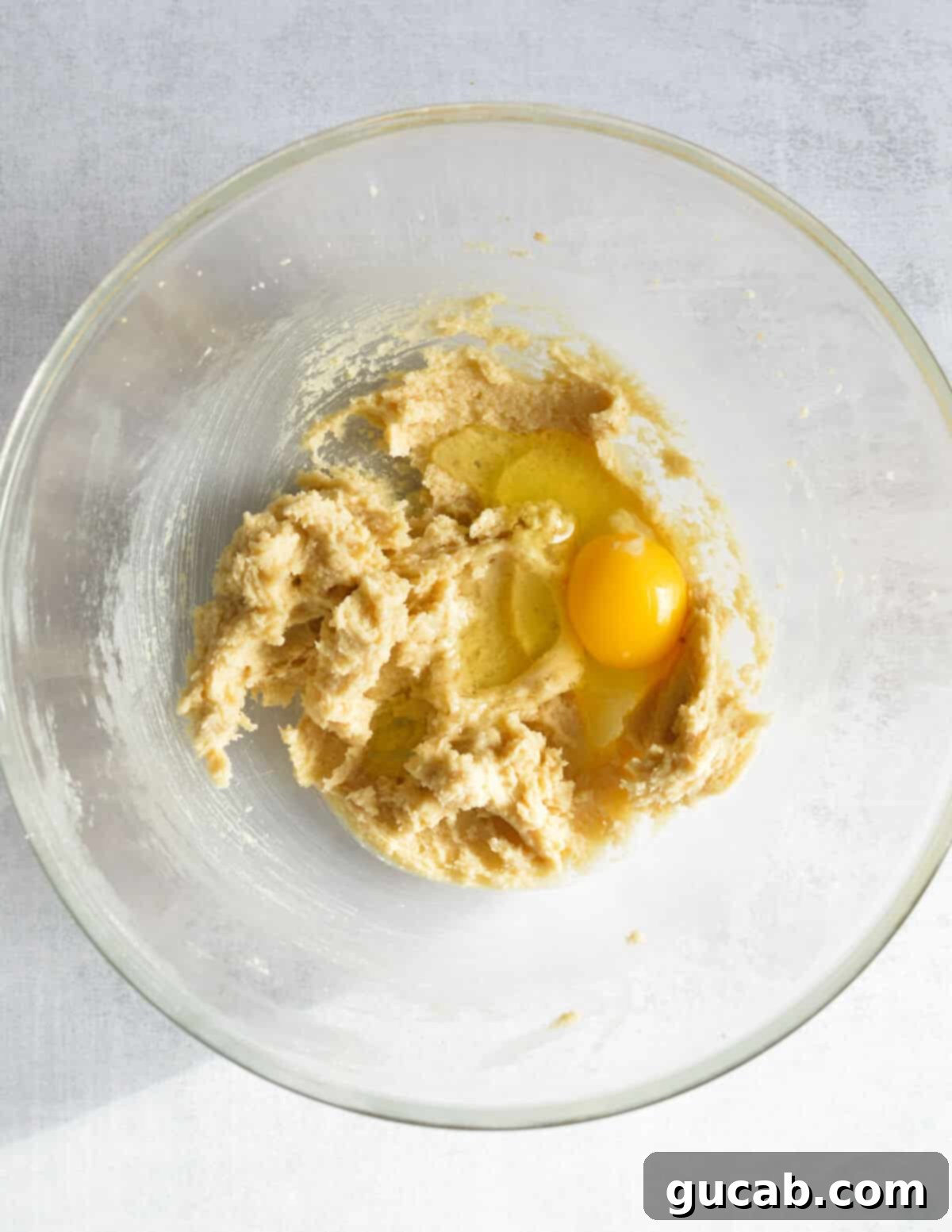 creamed butter and sugar in a bowl with an egg on top. 
