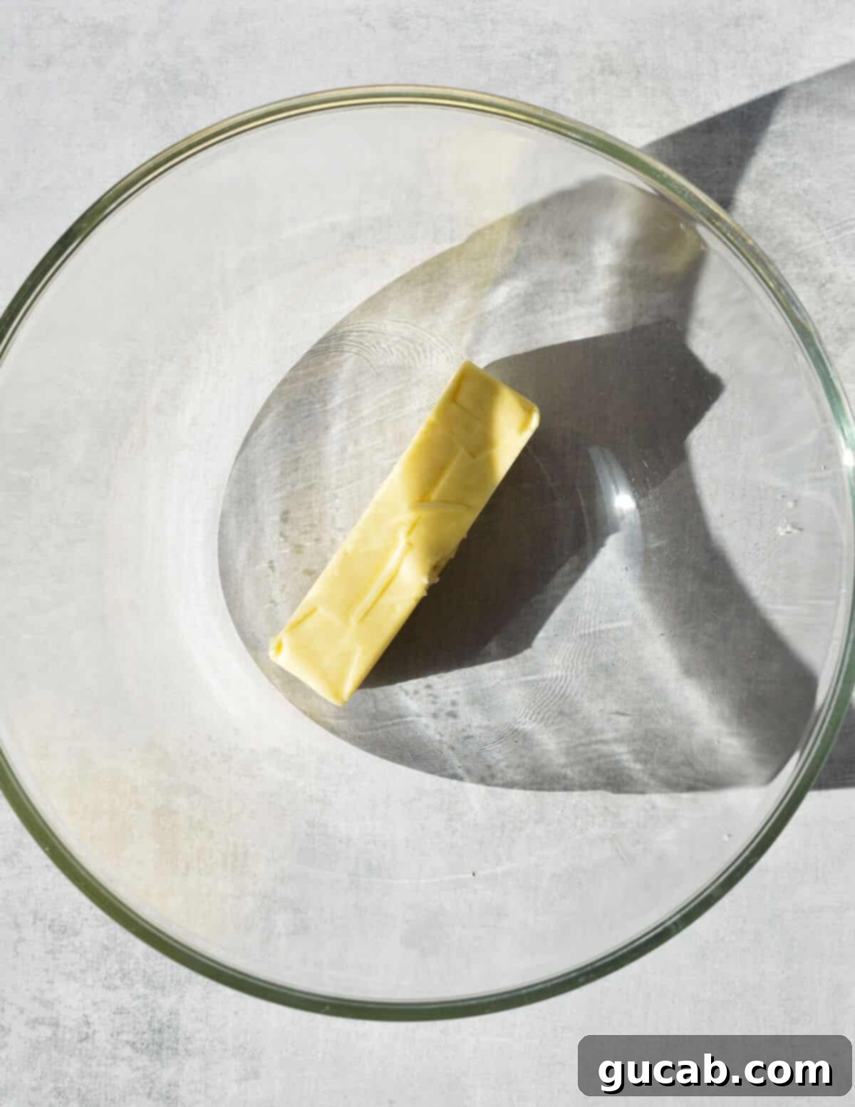 a bowl with a stick of butter in it.