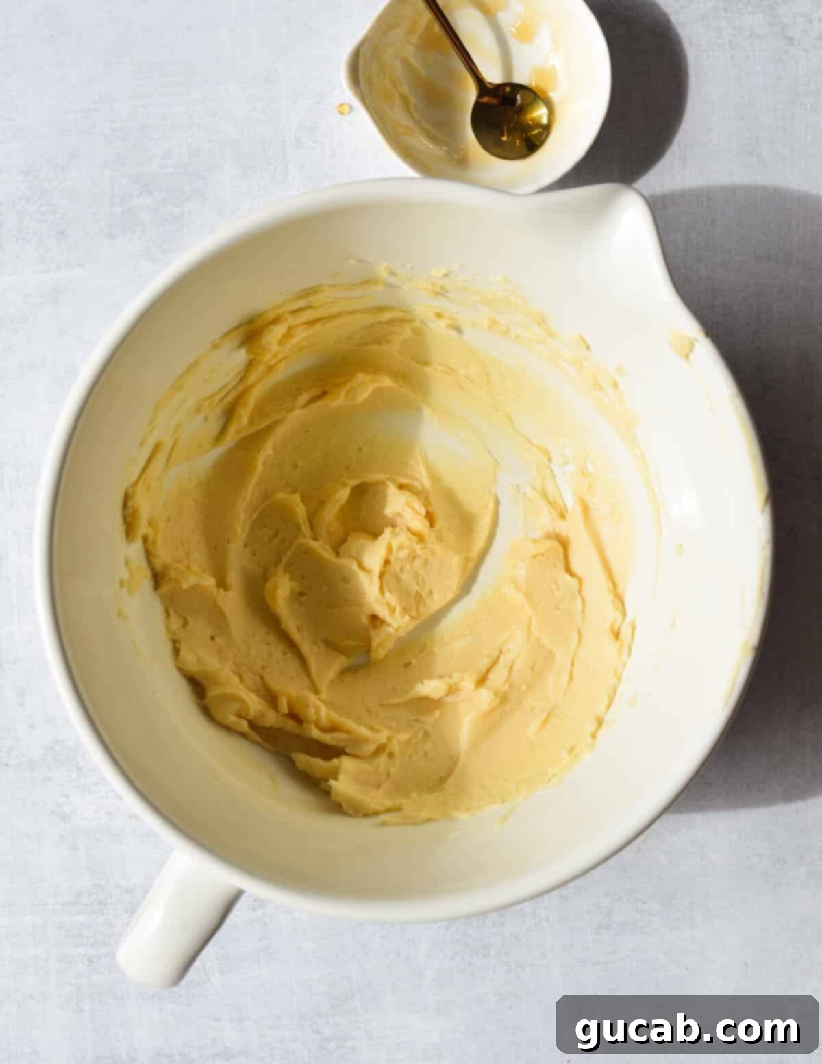 A bowl of honey butter after mixing, showing a smooth, creamy, and uniform texture.