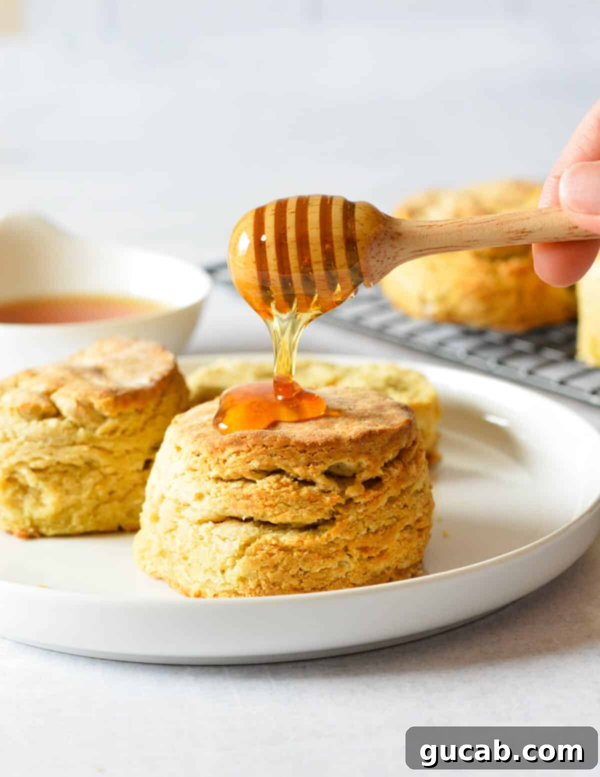 drizzling honey onto gluten free biscuits. 