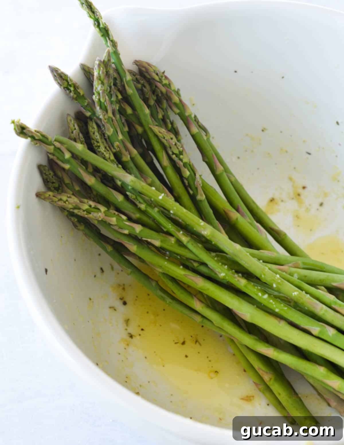 a bowl of asparagus in olive oil. 