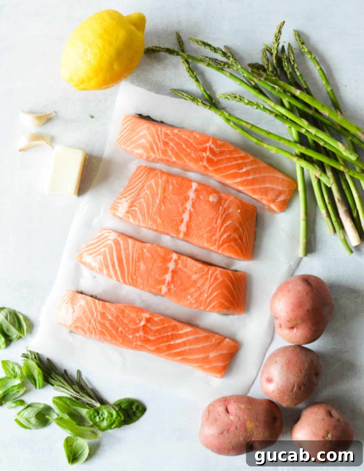 asparagus, salmon, lemon, butter, garlic, red potatoes, basil, rosemary. 