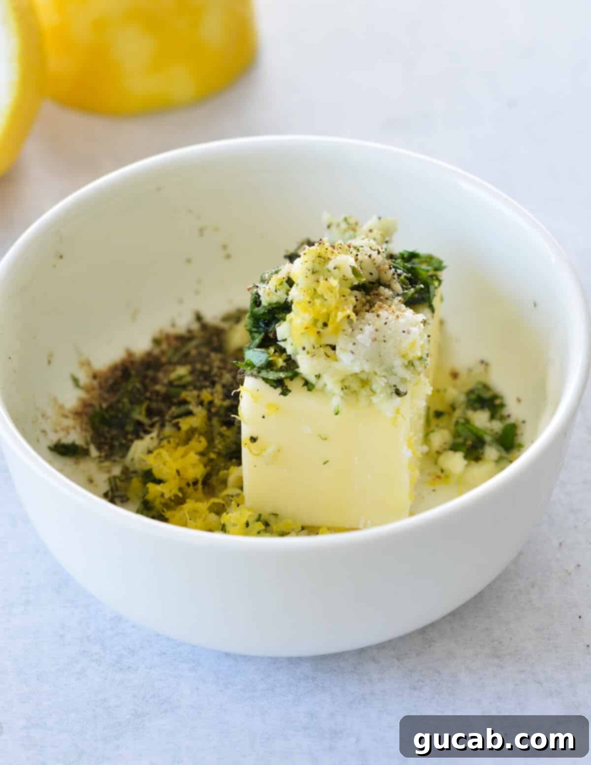 a bowl of softened butter with herbs and lemon zest. 
