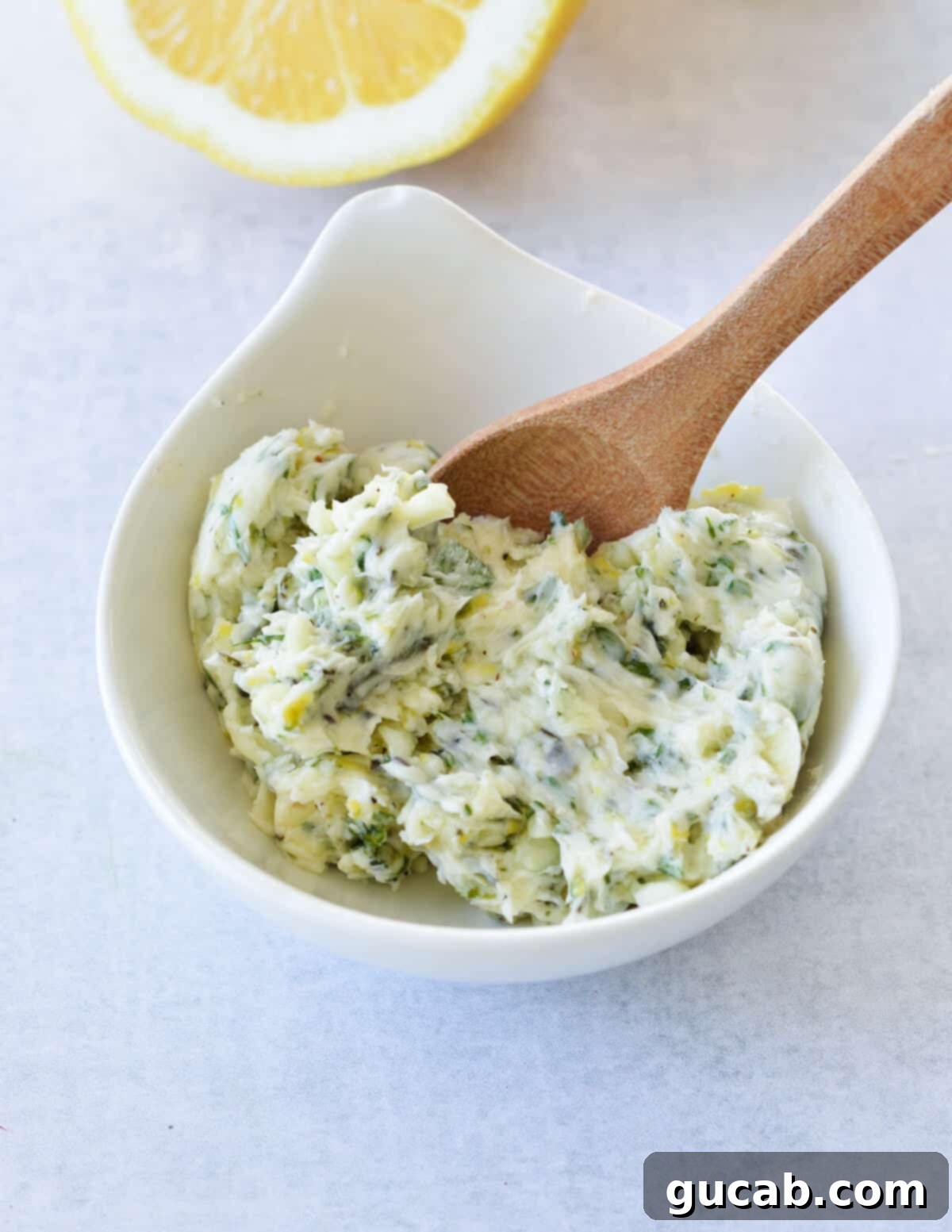 a small bowl of lemon herb butter. 
