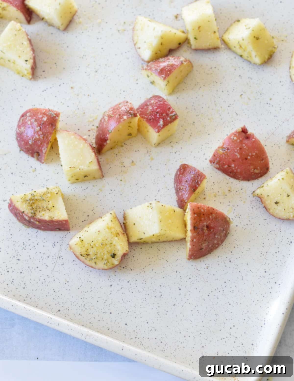 seasoned red potatoes on a sheet pan. 