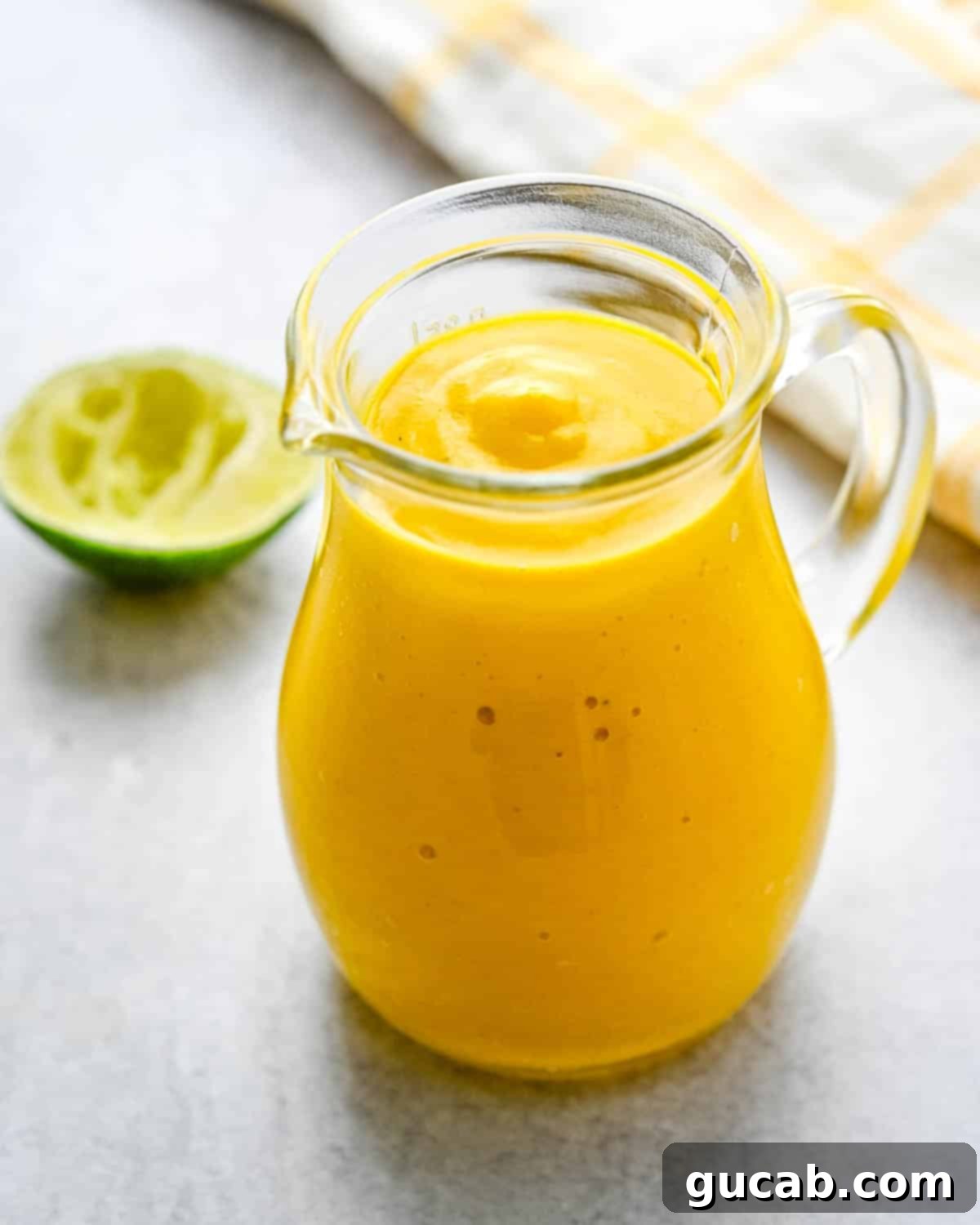 Sun-Kissed Mango Creations 13 A jar of zesty curried mango salad dressing.